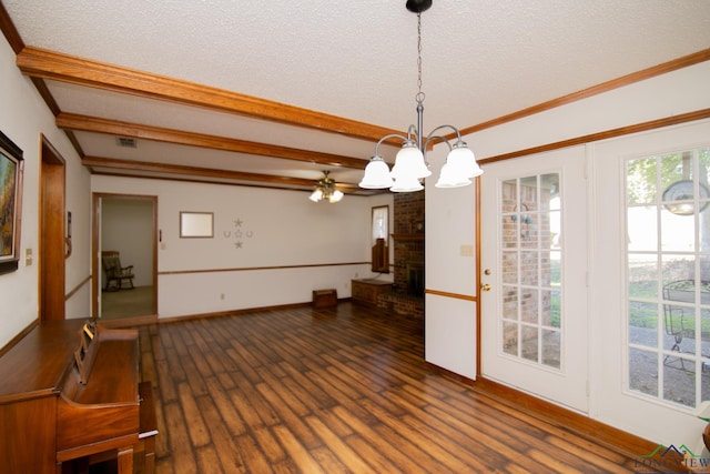 dining space with ceiling fan with notable chandelier, a textured ceiling, crown molding, dark wood-type flooring, and a fireplace