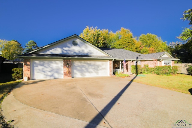 single story home featuring a garage and a front yard