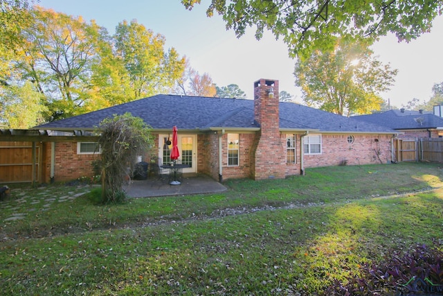 back of house featuring a yard and a patio