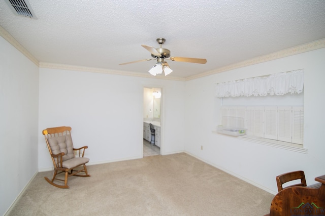 sitting room with a textured ceiling, light colored carpet, ceiling fan, and crown molding