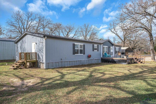 back of house with a wooden deck and a yard