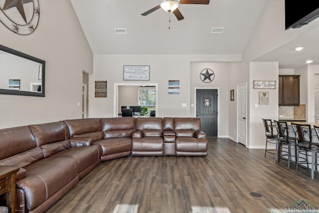 living room with ceiling fan, dark hardwood / wood-style floors, and high vaulted ceiling