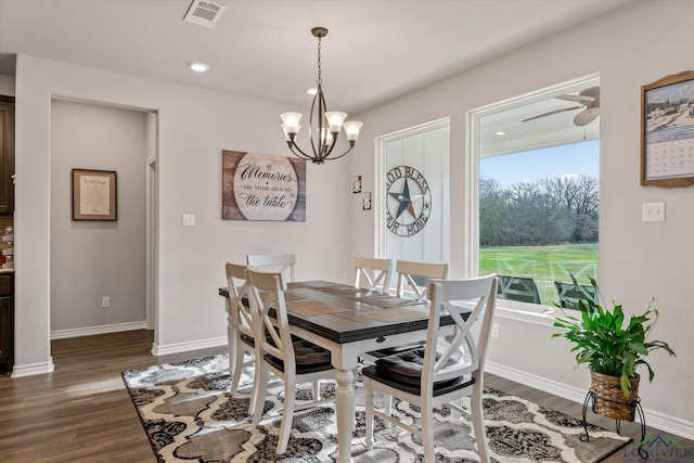 dining room with dark hardwood / wood-style floors and ceiling fan with notable chandelier