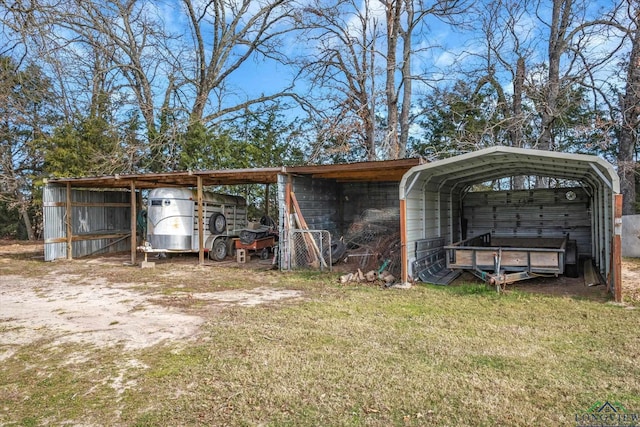 view of outdoor structure with a yard and a carport