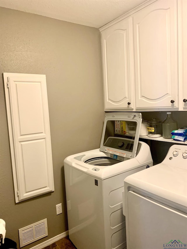 4401 Leland St, Marshall, TX 75672 - laundry room featuring washer and clothes dryer and cabinet space