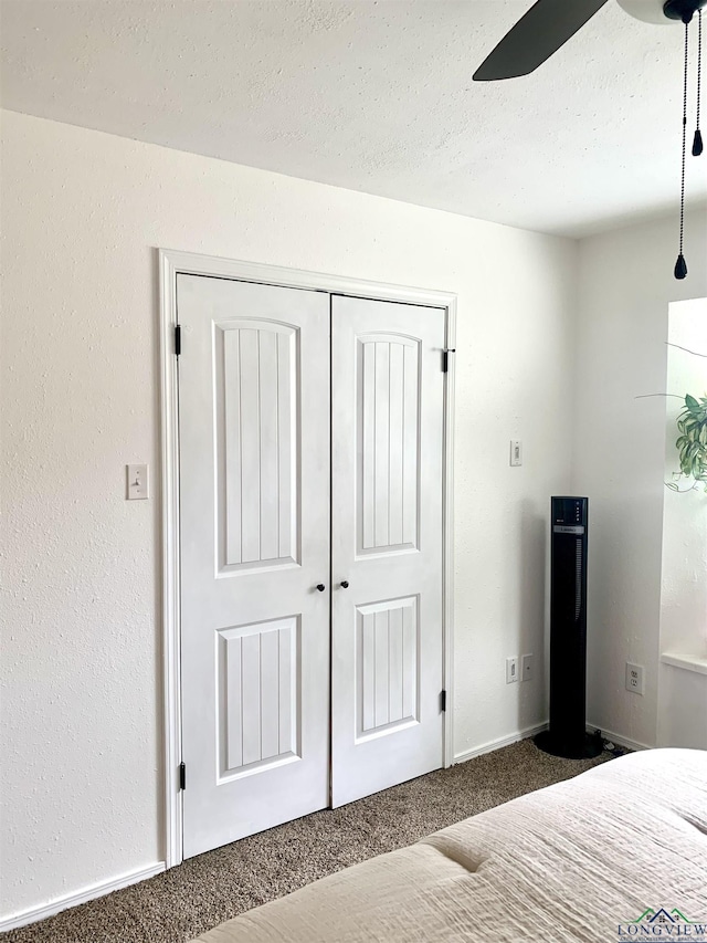 4401 Leland St, Marshall, TX 75672 - bedroom featuring dark carpet, a closet, and a textured ceiling