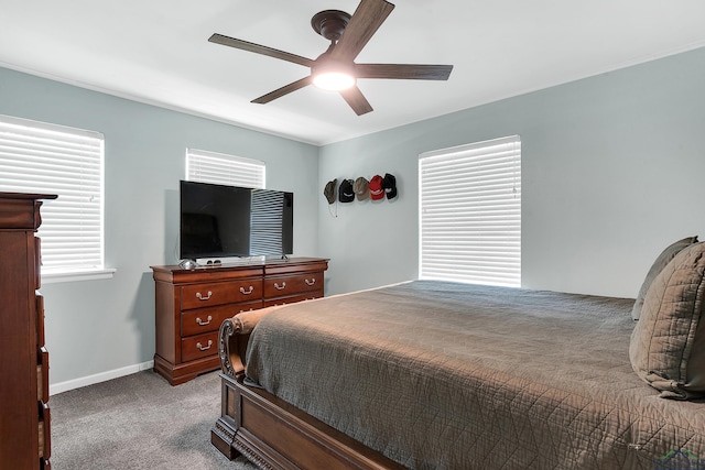 carpeted bedroom featuring ceiling fan and baseboards