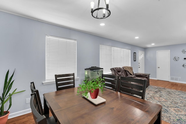 dining room with a chandelier, baseboards, recessed lighting, and wood finished floors