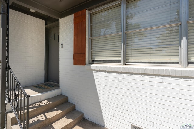 property entrance with brick siding