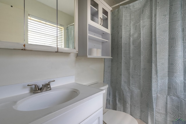 bathroom featuring toilet and vanity