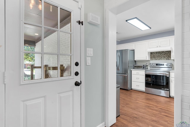 doorway with wood finished floors