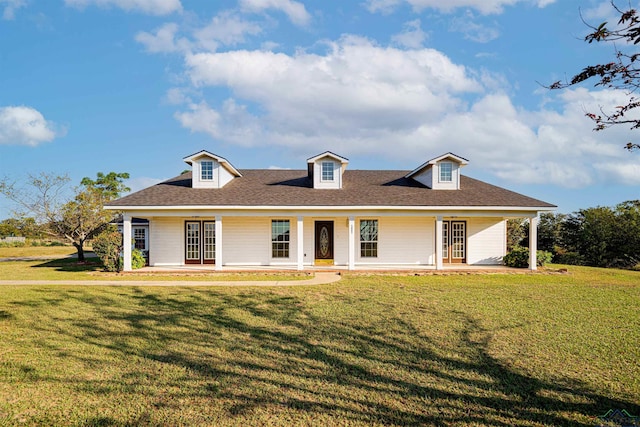 view of front of home with a shingled roof and a front yard