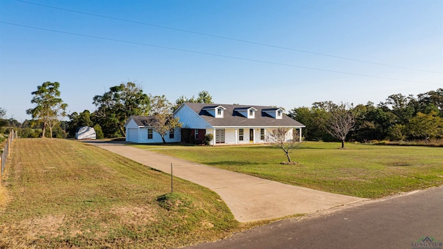 new england style home featuring driveway and a front yard