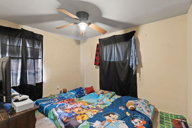 bedroom featuring ceiling fan and a textured ceiling