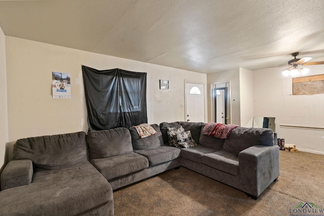 carpeted living room with ceiling fan and a textured ceiling