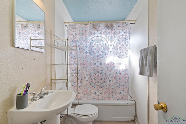 full bathroom with sink, shower / bath combination with curtain, a textured ceiling, and toilet