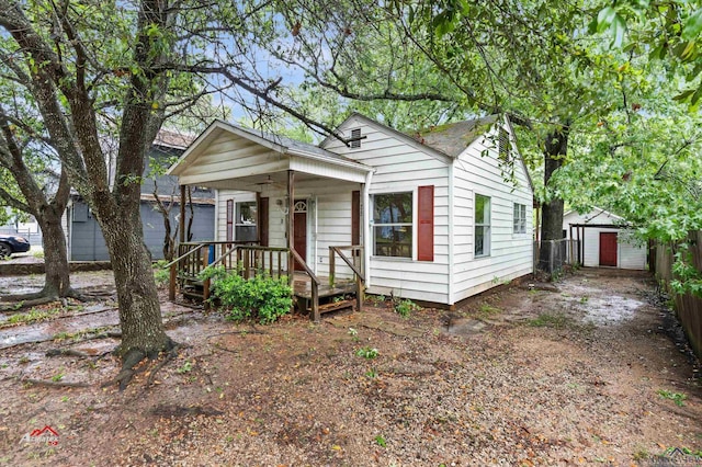 bungalow-style house featuring a storage unit