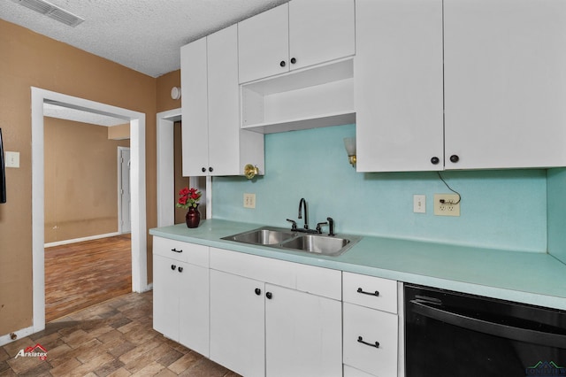 kitchen with dishwasher, white cabinets, sink, a textured ceiling, and light hardwood / wood-style floors