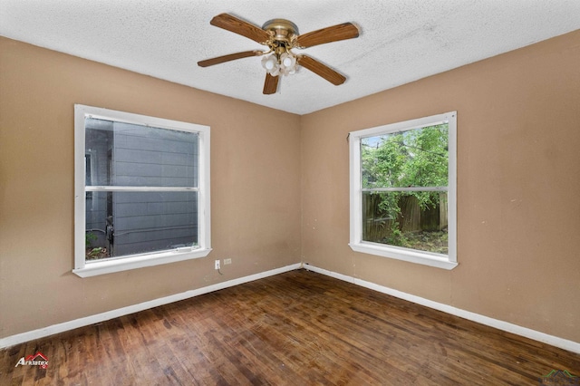 empty room with ceiling fan, hardwood / wood-style floors, and a textured ceiling