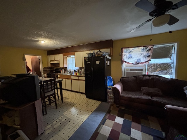 living room featuring light floors, ceiling fan, a textured ceiling, and cooling unit