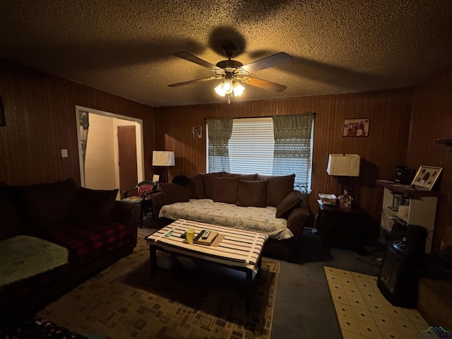 carpeted living area with a textured ceiling and a ceiling fan