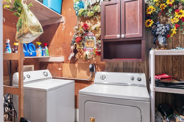 washroom featuring cabinets and washer and dryer