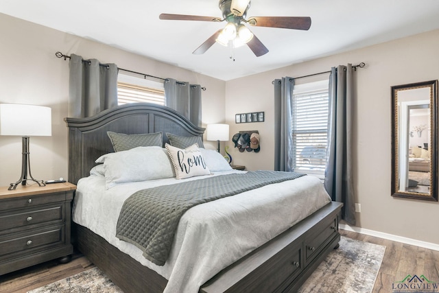 bedroom with ceiling fan and dark hardwood / wood-style flooring