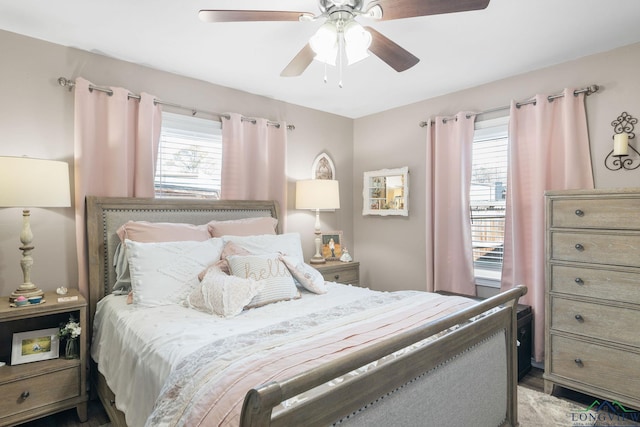 bedroom featuring multiple windows and ceiling fan