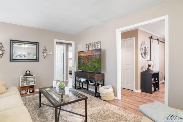 living room featuring wood-type flooring and a barn door