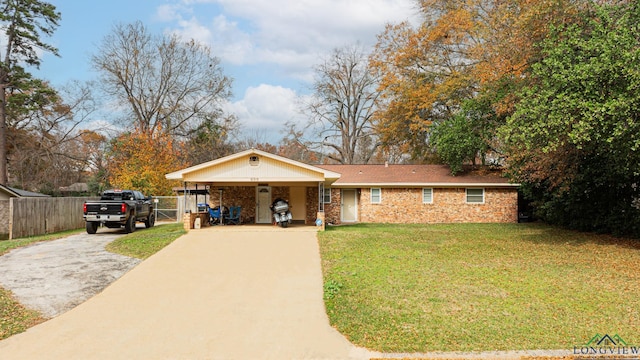 view of front of property with a carport and a front yard