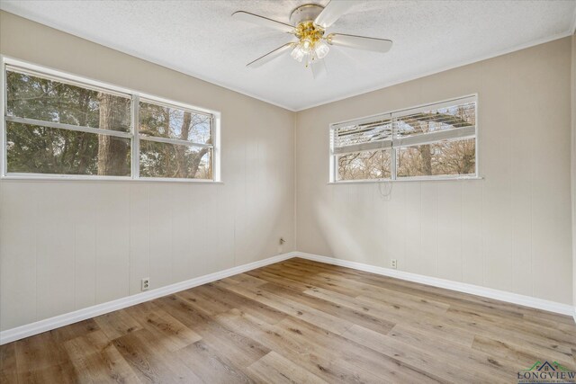 1480 Woodland Dr, Canton, TX 75103 - empty room with a textured ceiling, plenty of natural light, light hardwood / wood-style floors, and ceiling fan