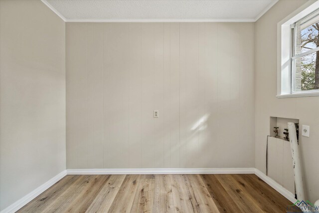 1480 Woodland Dr, Canton, TX 75103 - interior space featuring hookup for a washing machine, crown molding, a textured ceiling, and light wood-type flooring