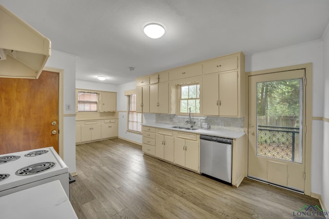 kitchen with cream cabinets, sink, stainless steel dishwasher, decorative backsplash, and range hood