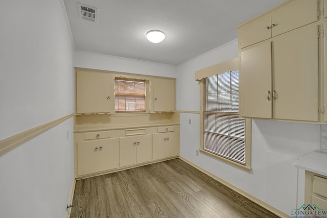 kitchen with light hardwood / wood-style floors and cream cabinets