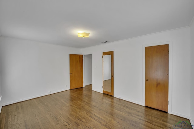 unfurnished room featuring hardwood / wood-style floors