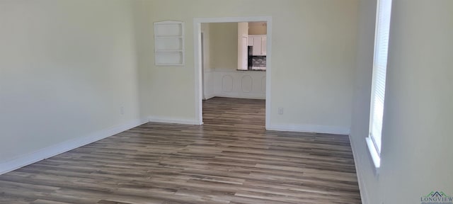 spare room with dark wood-type flooring