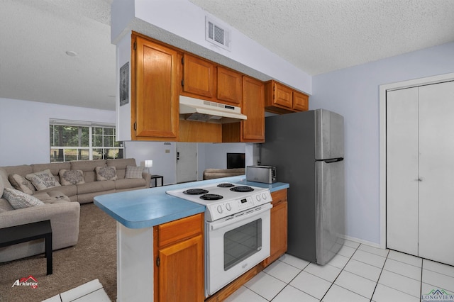 kitchen with white electric stove, light tile patterned floors, a textured ceiling, kitchen peninsula, and stainless steel refrigerator