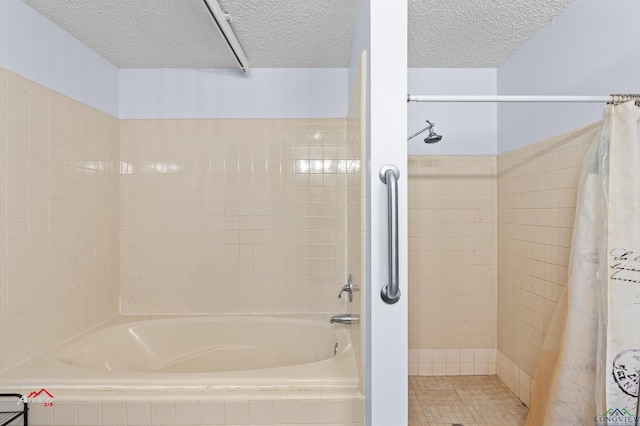 bathroom with separate shower and tub and a textured ceiling