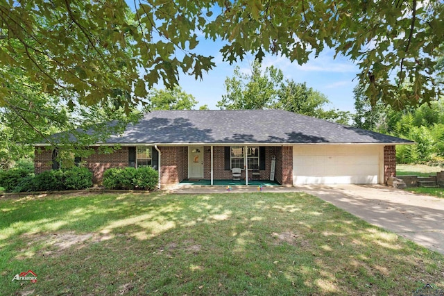 ranch-style house with covered porch, a garage, and a front lawn