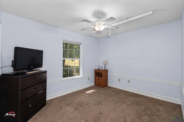 bedroom with ceiling fan, carpet floors, and a textured ceiling