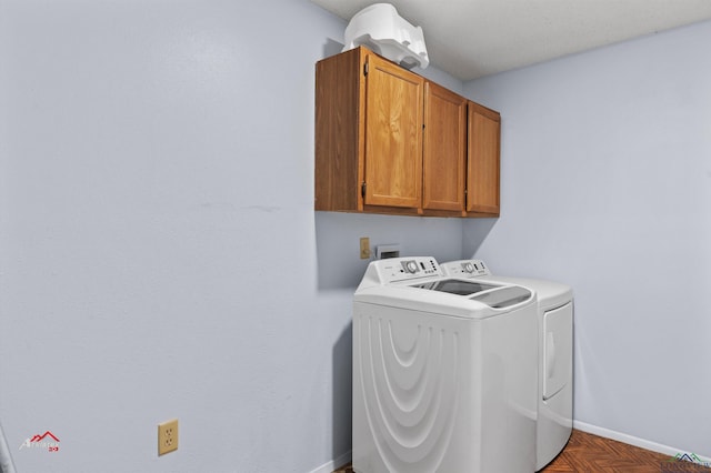 laundry area with washer and clothes dryer, cabinets, and parquet floors