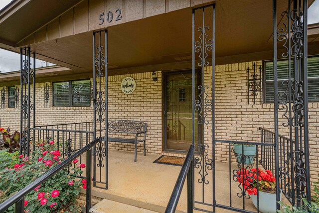 502 Hillcrest, Hughes Springs, TX 75656 - entrance to property featuring a porch and brick siding