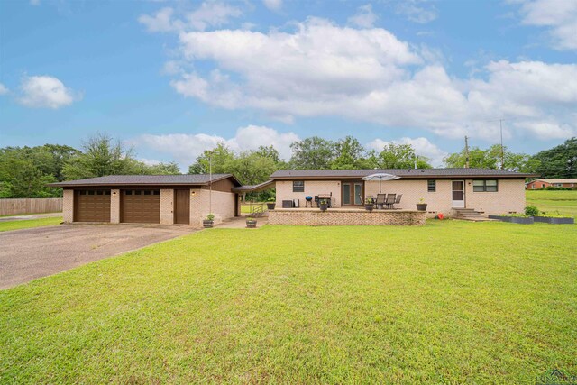 502 Hillcrest, Hughes Springs, TX 75656 - view of front of home featuring a front lawn, brick siding, driveway, and fence