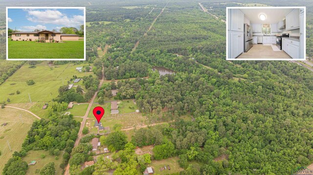 502 Hillcrest, Hughes Springs, TX 75656 - birds eye view of property with a forest view