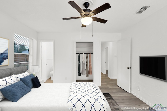 bedroom with hardwood / wood-style floors, ensuite bath, a closet, and ceiling fan