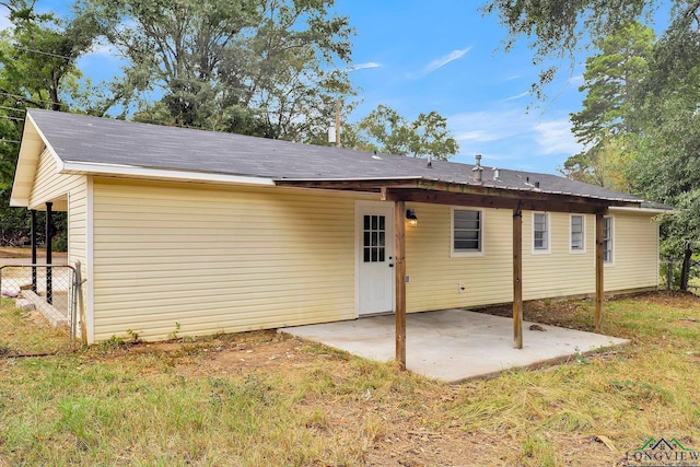 back of house featuring a lawn and a patio