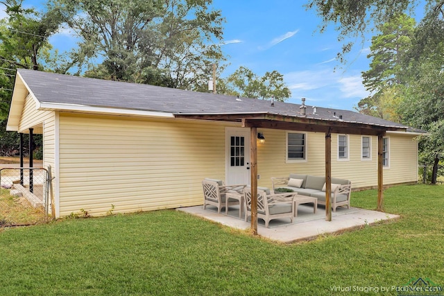 back of house featuring a lawn, an outdoor living space, and a patio area