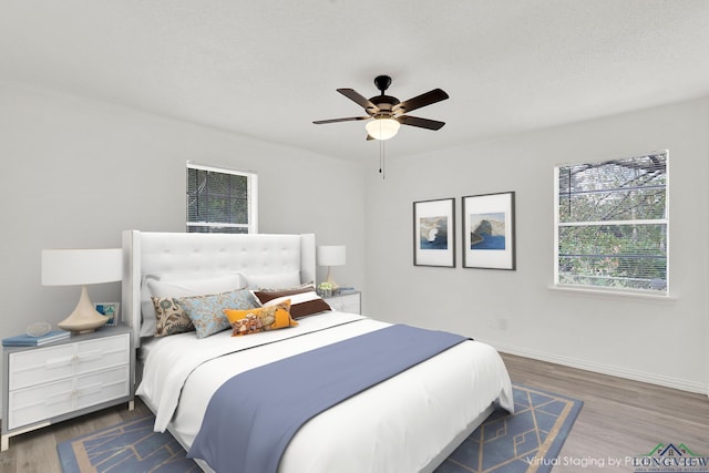 bedroom featuring ceiling fan and dark hardwood / wood-style flooring