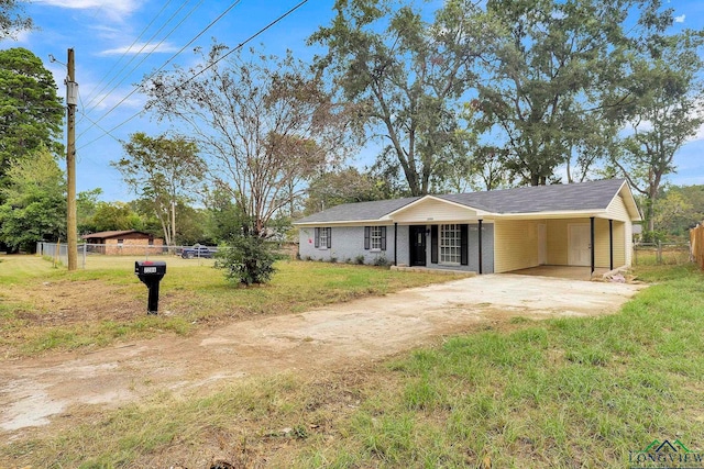 ranch-style home with a carport and a front lawn