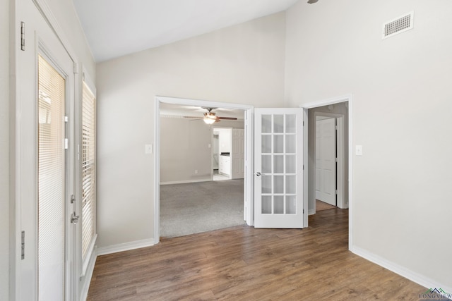 interior space with visible vents, a ceiling fan, baseboards, and french doors